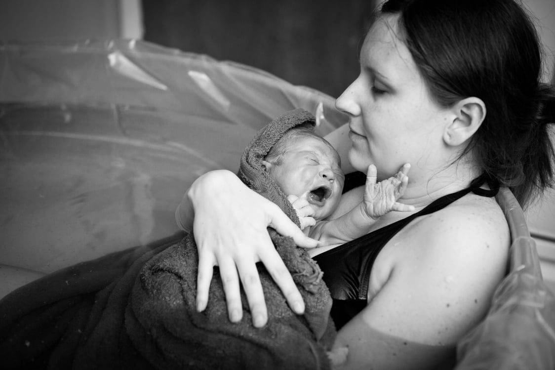 Mother Embracing Her Newborn after Home Water Birth