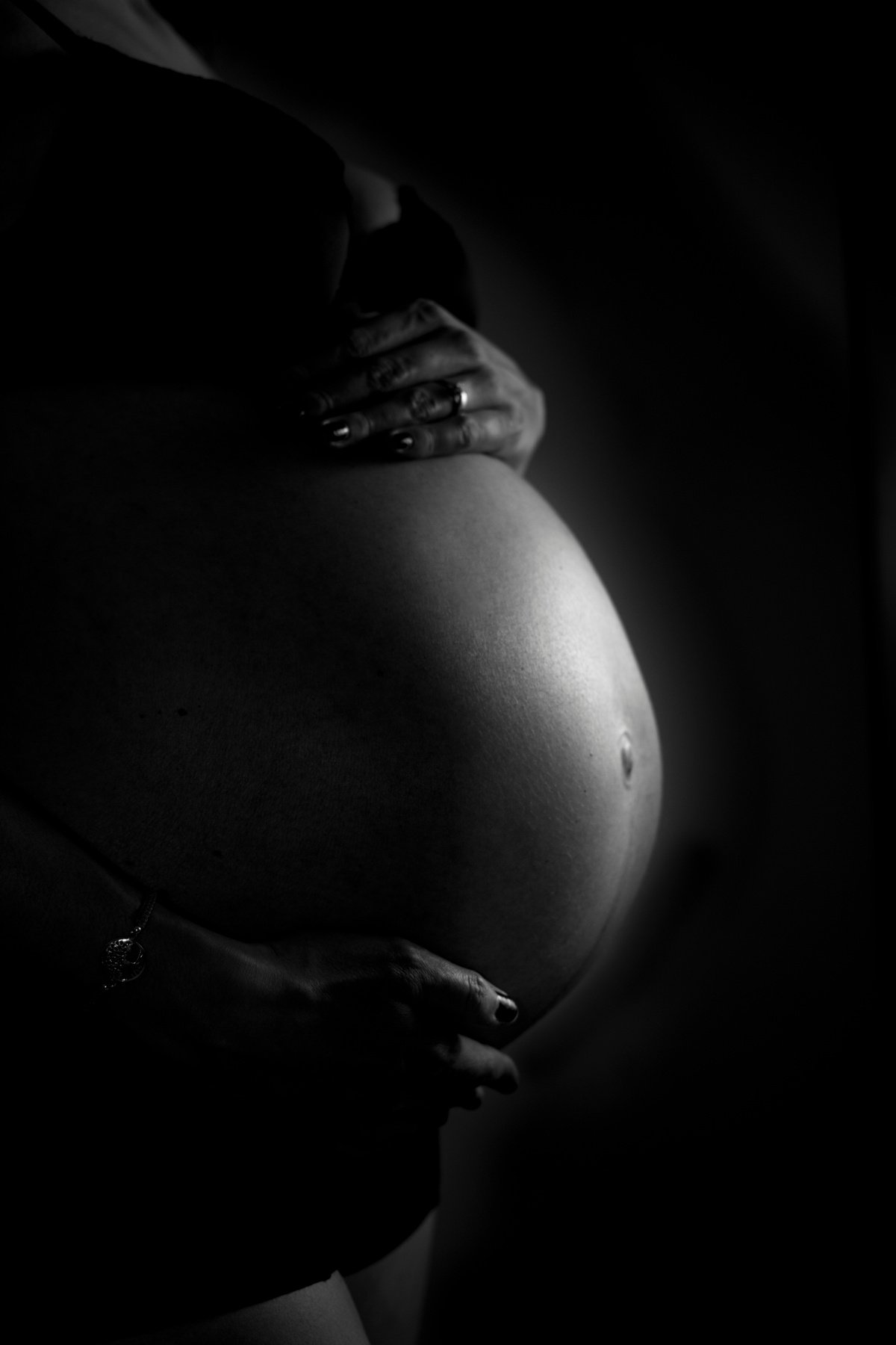 Black and White Photo of a Woman's Pregnant Belly